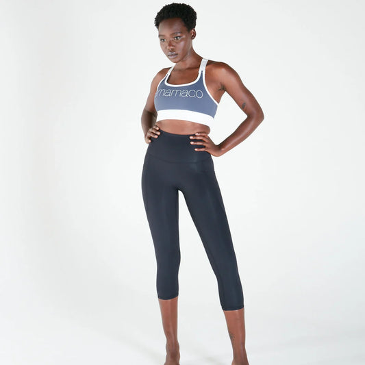 A diverse group of mothers in comfortable activewear, some stretching gently, others smiling and interacting, representing the real and supportive nature of motherhood.